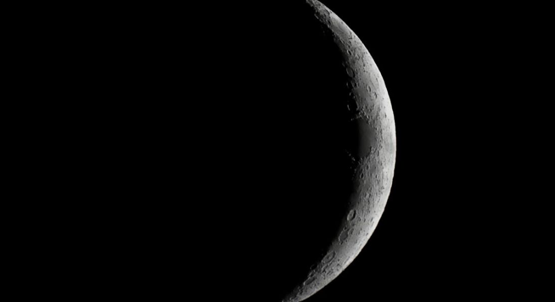 Moon waxing crescent close-up representing a dark side.
