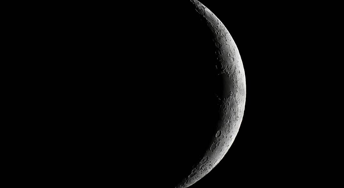 Moon waxing crescent close-up representing a dark side.