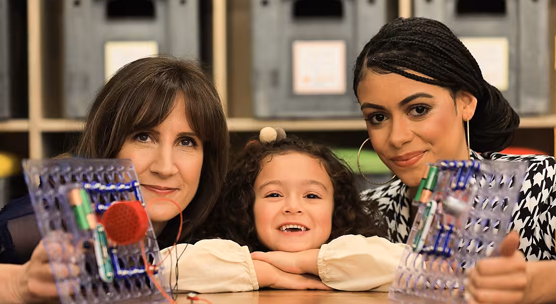 Two women and a young girl are looking into the camera at the launch of Engineers Week.