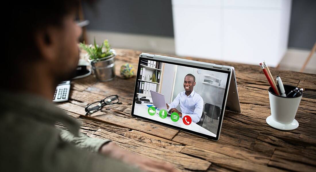 Two men are talking to each other through video chat.