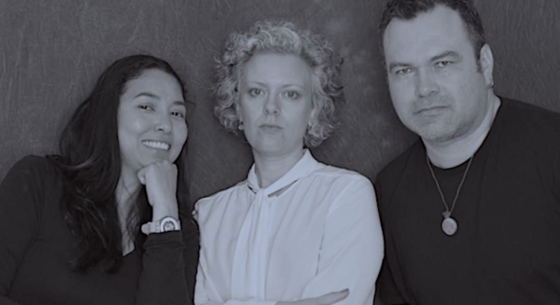 The three co-founders of the Cueva Gallery are pictured in black and white against a black background, and are looking into the camera.