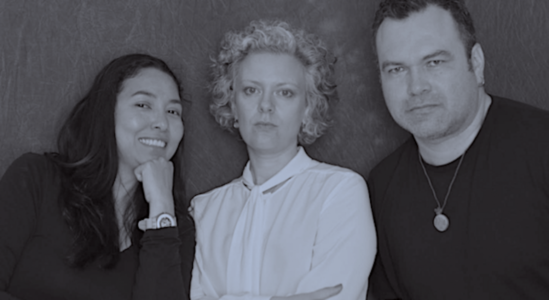 The three co-founders of the Cueva Gallery are pictured in black and white against a black background, and are looking into the camera.