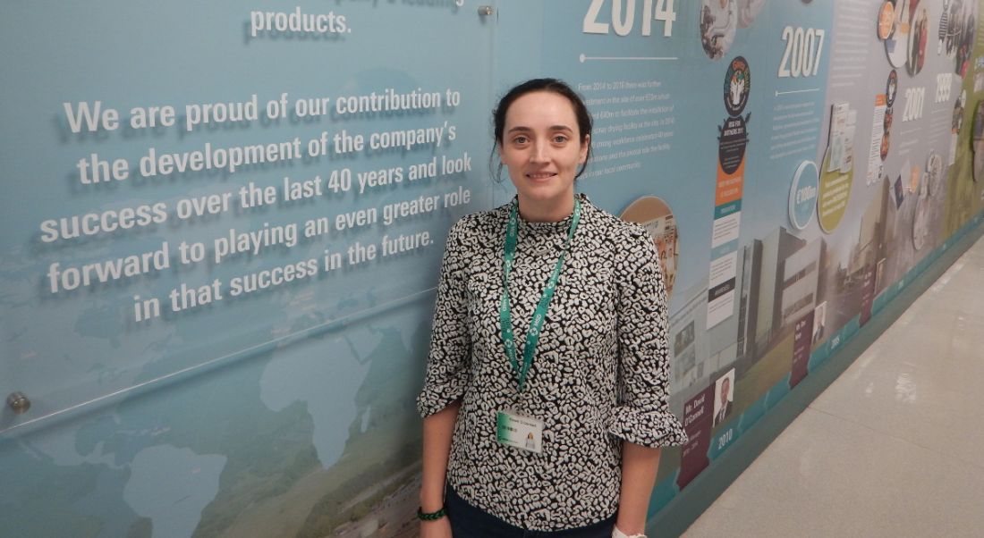 Eileen O’Connell of MSD is standing against a wall of information and smiling into the camera.