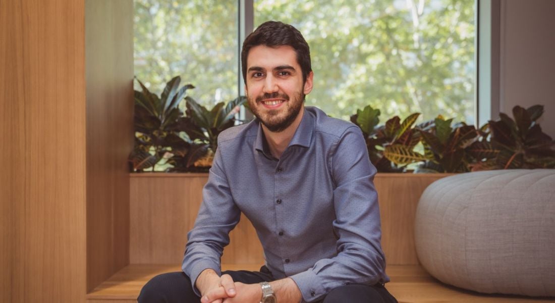 Javier Biosca of Viasat is sitting in a modern office and smiling into the camera.