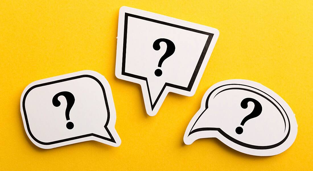 Three differently shaped speech bubbles with question marks inside, against a yellow background.