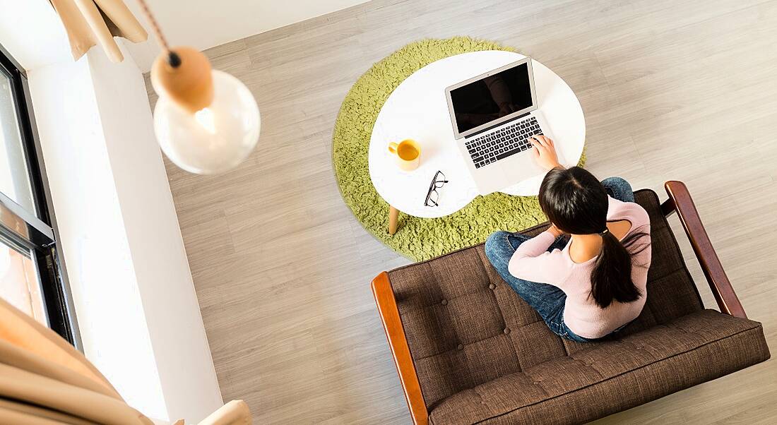 Top view of woman using computer for working from home.