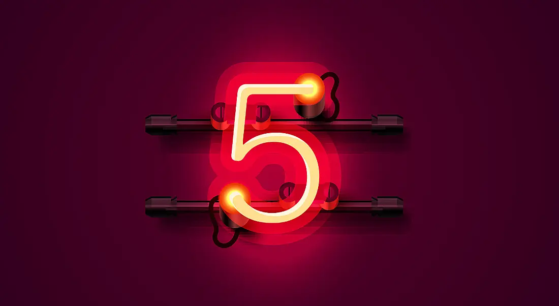 A lit up number 5 against a dark red background.