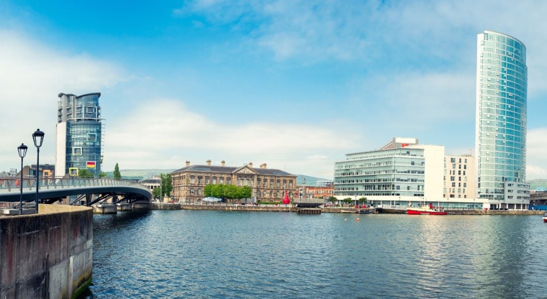 Panoramic view of the river Lagan in Belfast city, with office blocks overlooking the water.