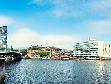 Panoramic view of the river Lagan in Belfast city, with office blocks overlooking the water.