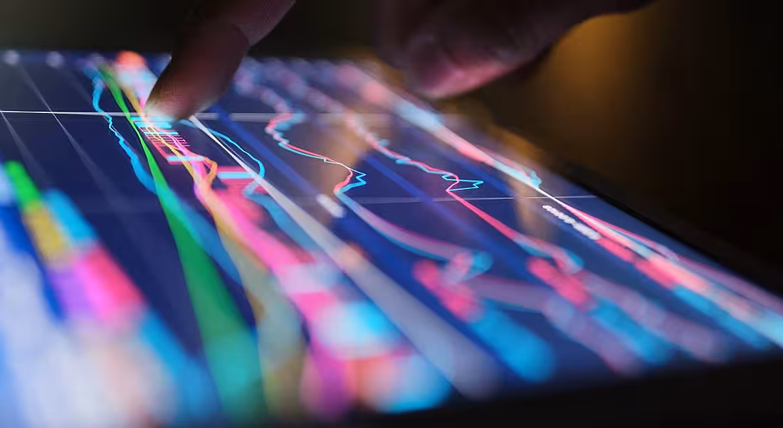 A person is interacting with data on a tablet screen, symbolising a career in big data.