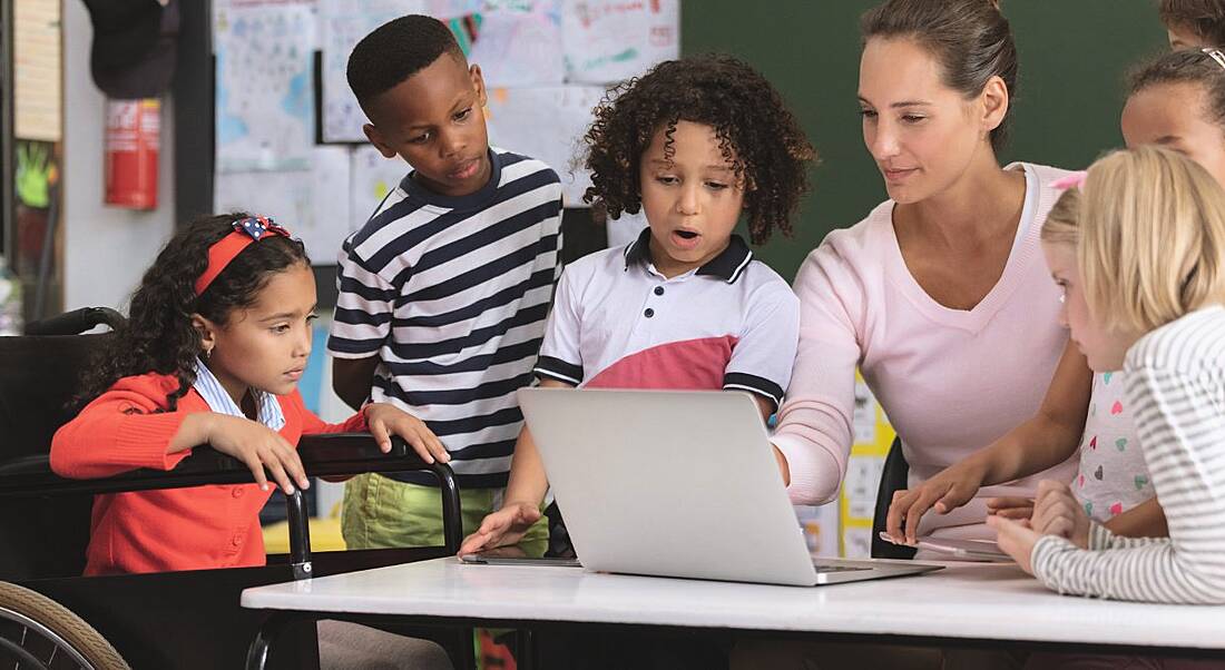 School students are being taught by their teacher in a classroom setting.