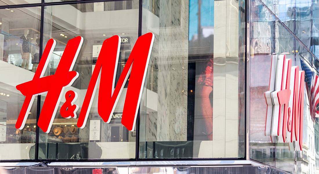 H&M logo on glass windows of store in New York City.