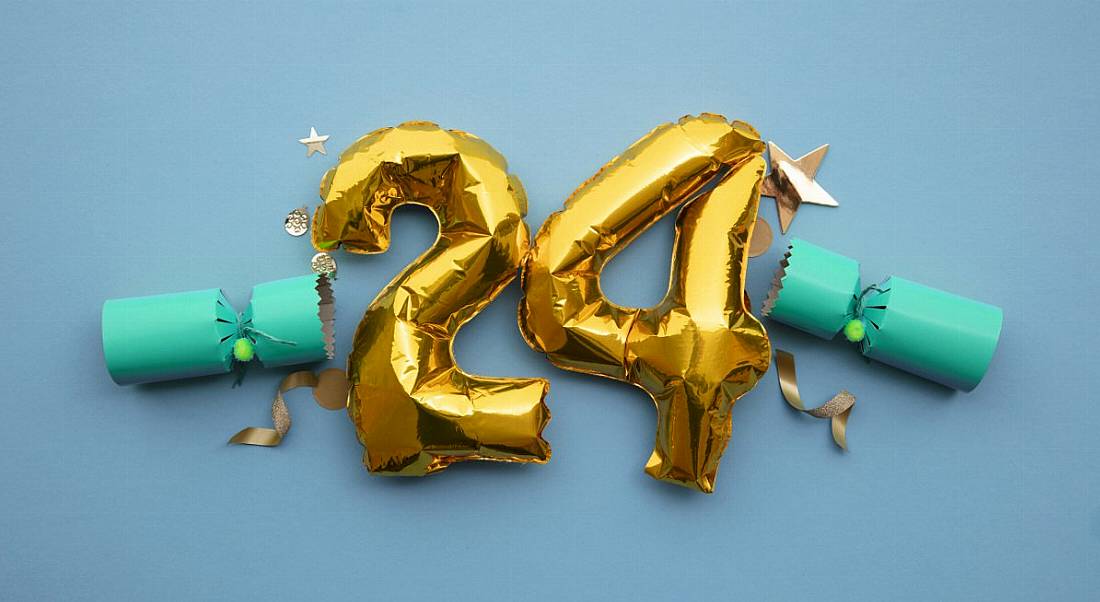 Gold foil number 24 balloons against a blue background.