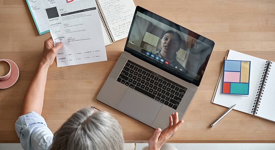 Two women are speaking to each other over a video call during a remote job interview.