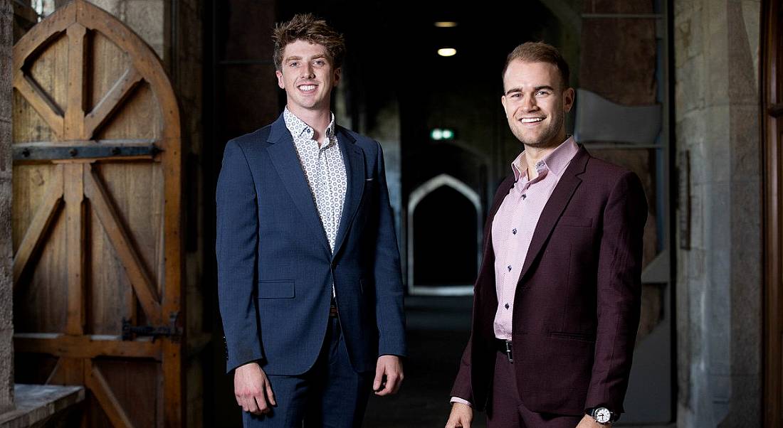 The co-founders of Yooni are standing together in a dark corridor at University College Cork and smiling into the camera.