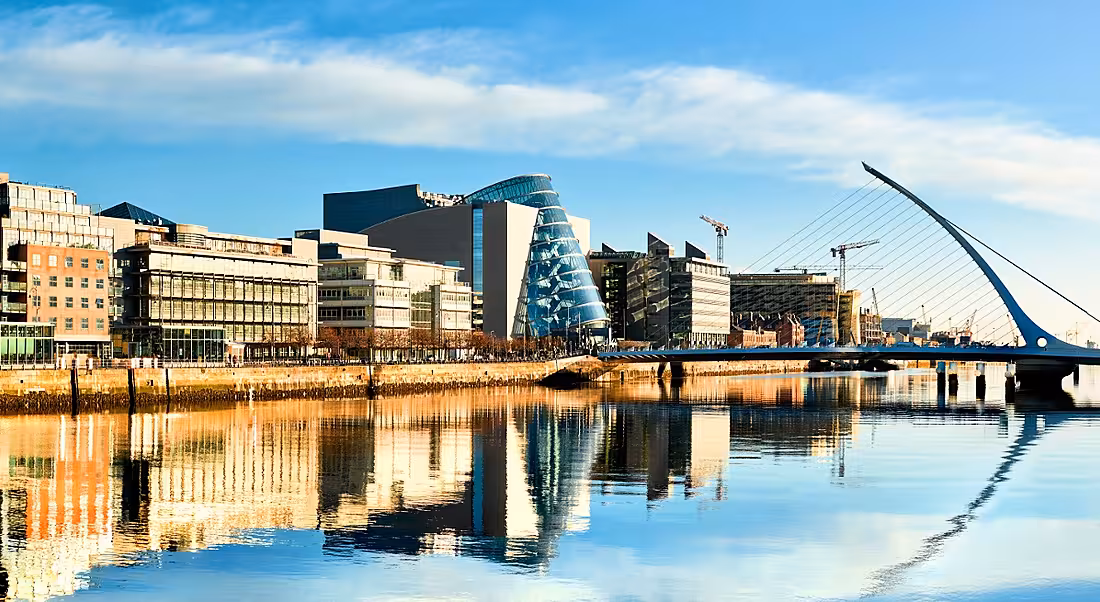 Modern buildings and offices along the River Liffey in Dublin on a bright sunny day.