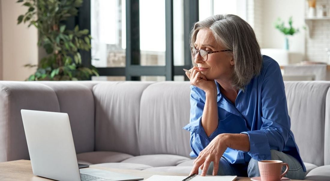 A professional woman is working remotely from her bright, modern home.