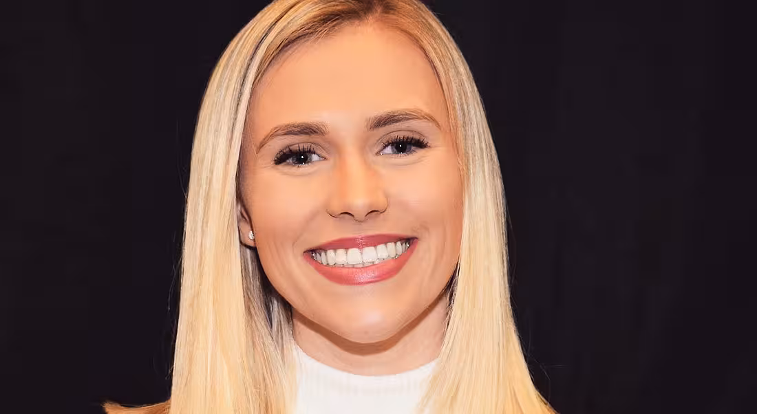 Leah O’Keeffe from the Johnson & Johnson GOLD programme is smiling into the camera against a dark background.