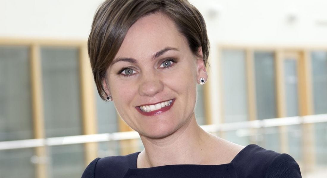 A headshot of Sarah McDonough standing in an office space.