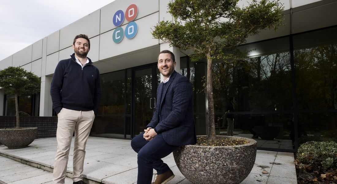 Frankie McSwiney and Brian Moran smiling and posing outside of the Swords NoCo facility.