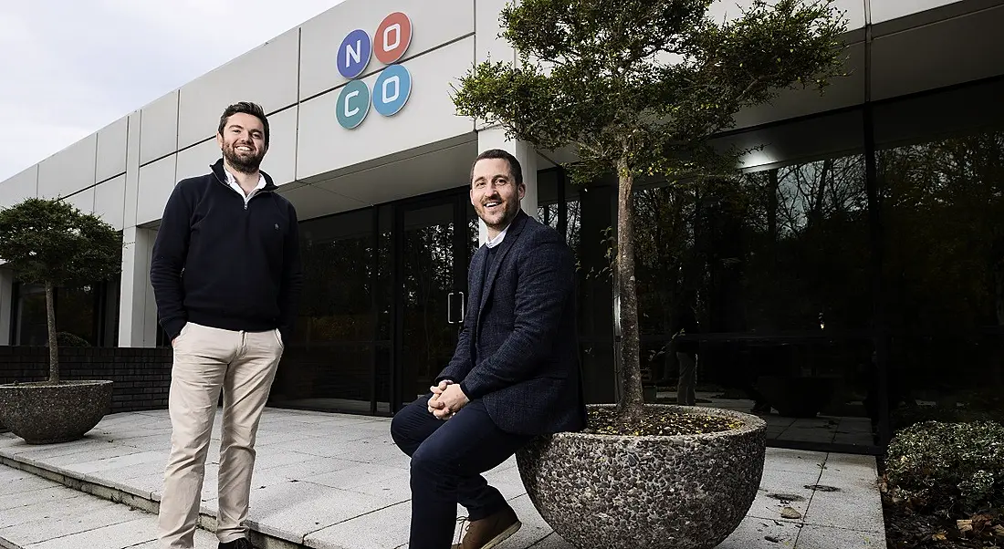 Frankie McSwiney and Brian Moran smiling and posing outside of the Swords NoCo facility.