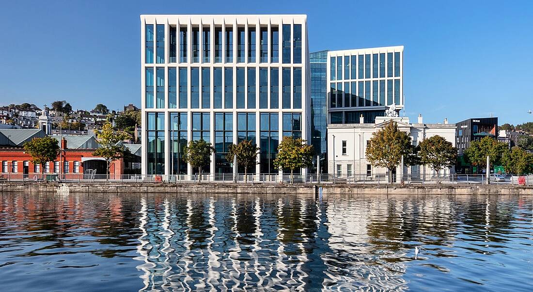 3D render of the Penrose Dock site with a body of water in front of it.