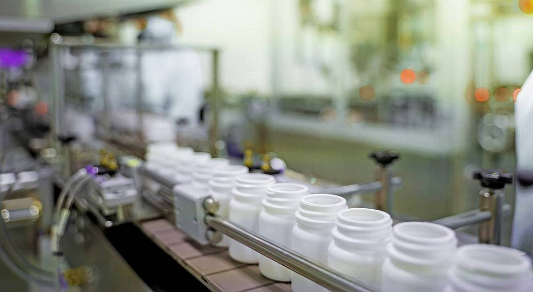 A pharmaceutical manufacturing line with plastic bottles.