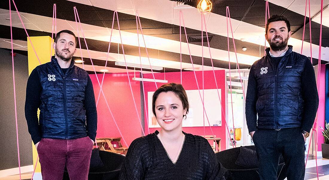 The founders of NoCo are with Huckletree’s general manager in a colourful, modern workspace.