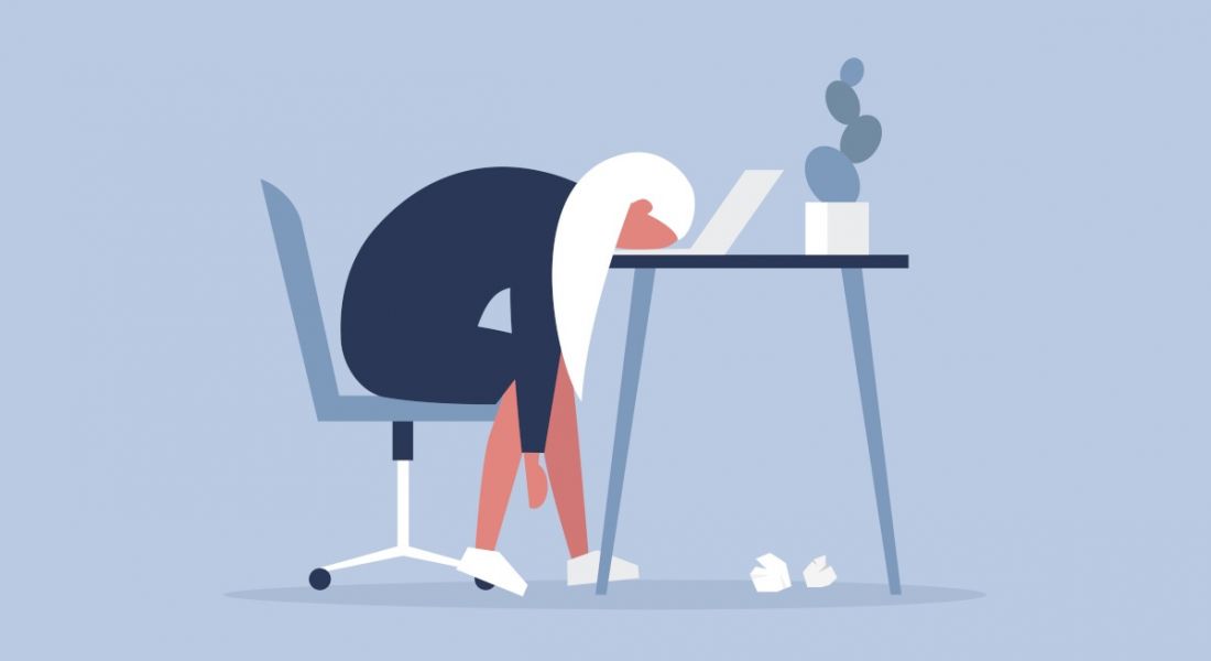 Illustration of a worker who is tired or bored of her job and is resting her head on her desk.