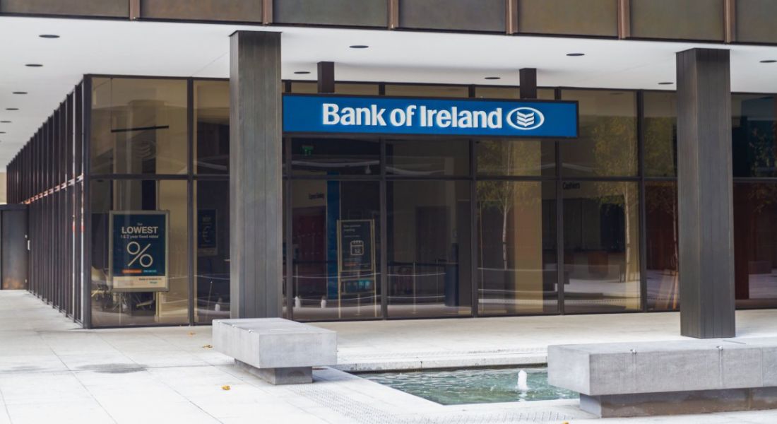 A Bank of Ireland branch in Dublin with the company logo on a blue sign at the top of the doors.
