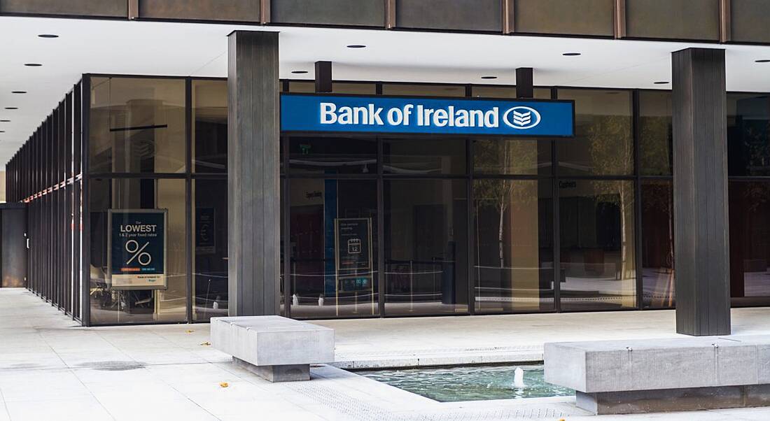 A Bank of Ireland branch in Dublin with the company logo on a blue sign at the top of the doors.