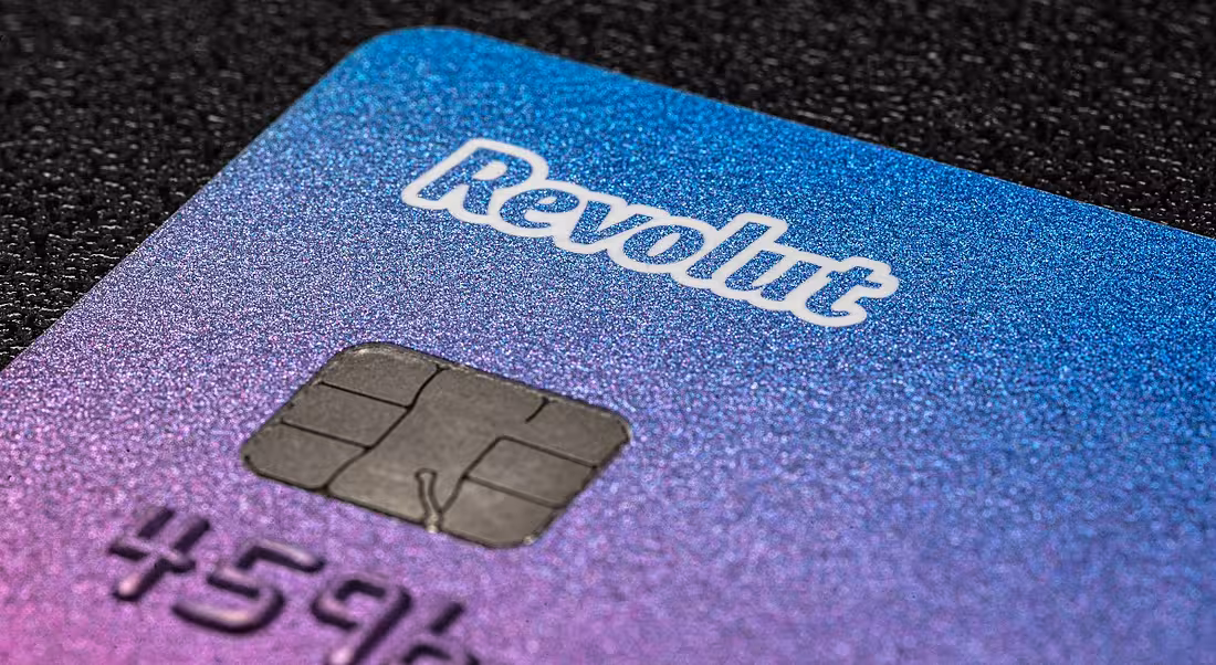 Close-up of a Revolut bank card on a dark surface.