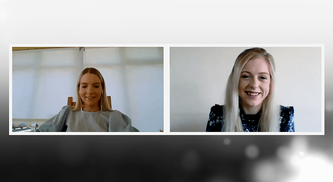 Two young women are smiling while talking to each other about mentorship on a video call.