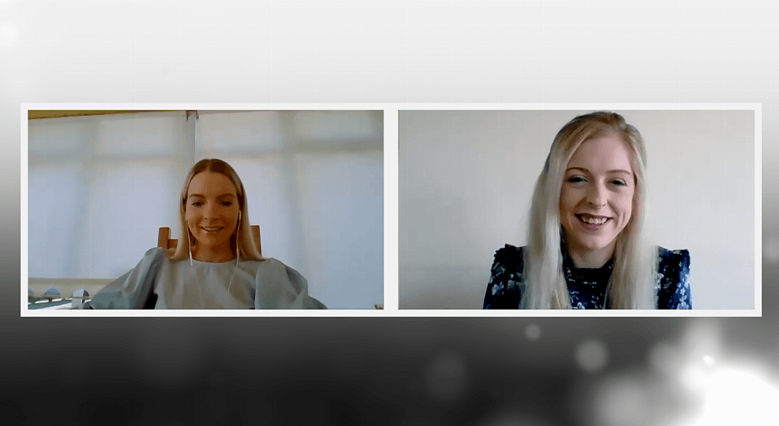 Two young women are smiling while talking to each other about mentorship on a video call.