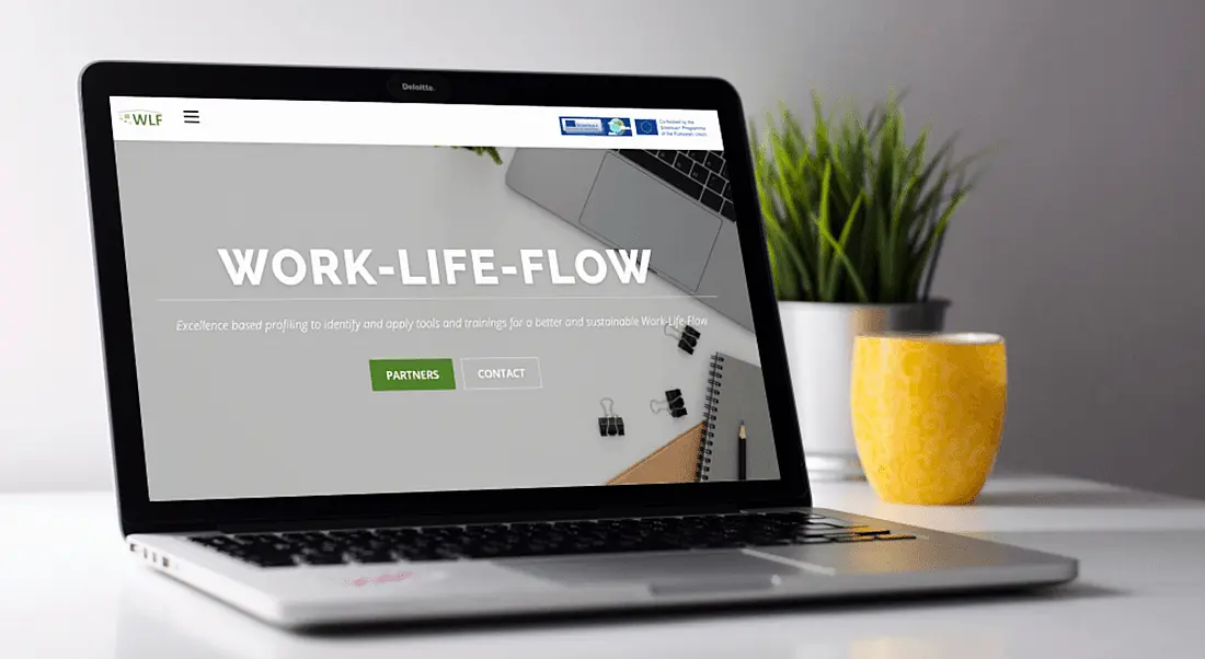 A laptop is open with Work-Life-Flow project branding on the screen.