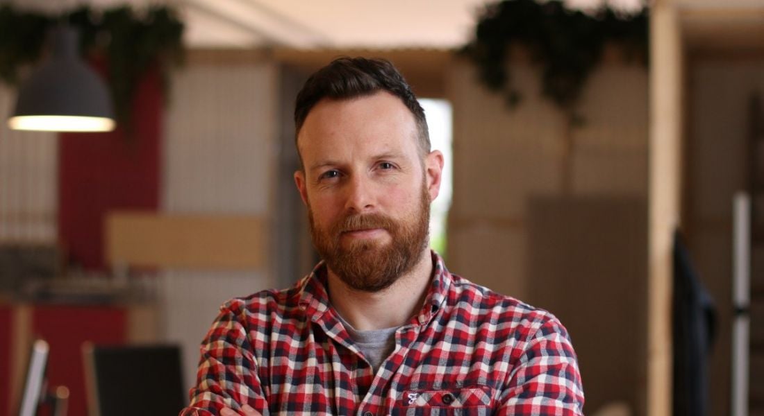 A headshot of Brian Herron, founder and director of Each&Other. He’s wearing a check shirt.