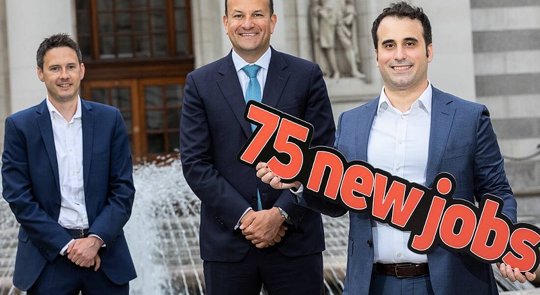 Leo Varadker stands smiling beside Patrick O’Callaghan and Michael Perez. Michael Perez is holding a cut-out that says '75 New Jobs'.