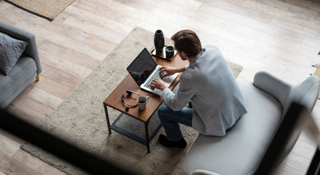 A man working at home on a laptop to symbolise remote working.