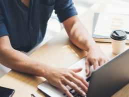 A man working at home on a laptop to symbolise remote working.