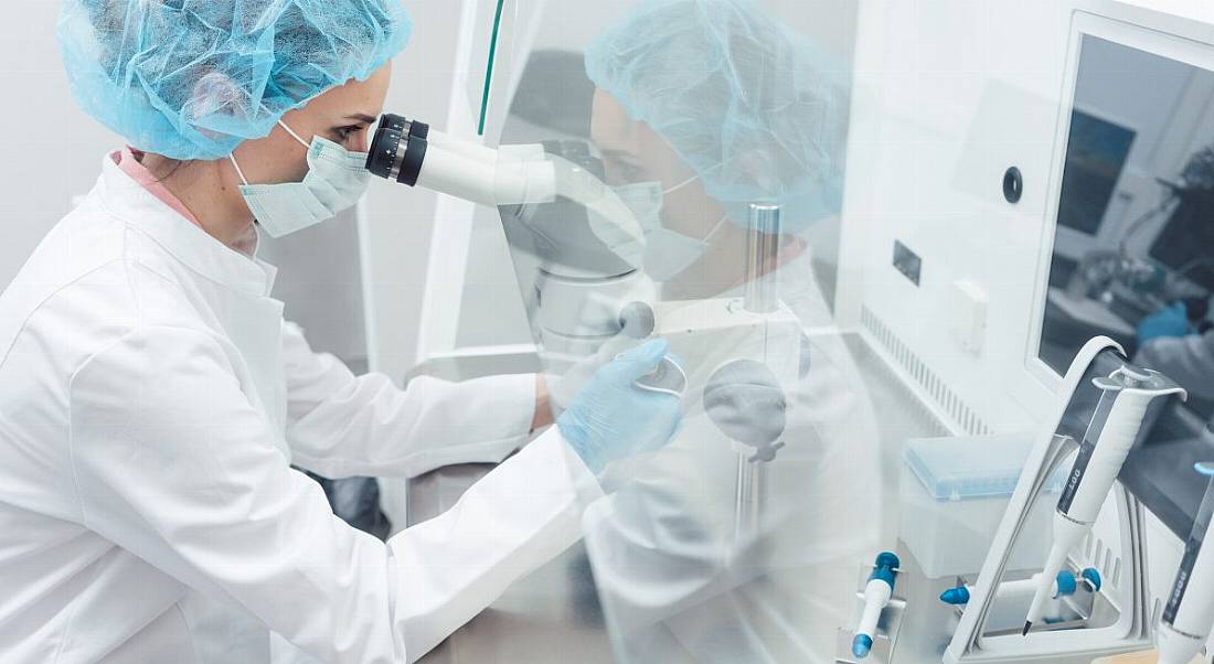 A stock image of a scientist working in a biotech lab.