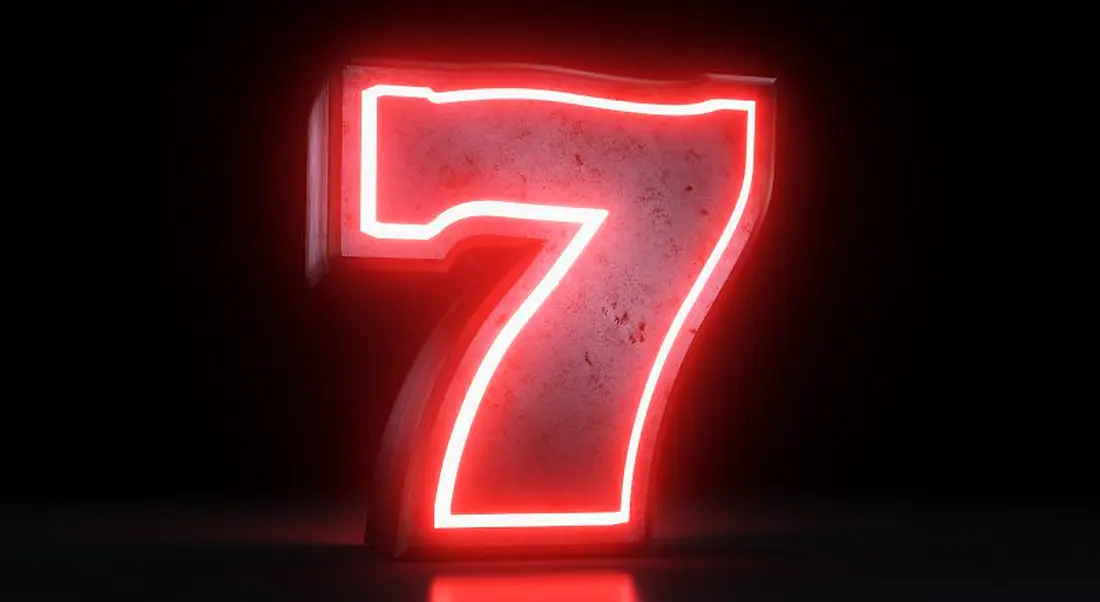 A large neon red number seven against a black background.