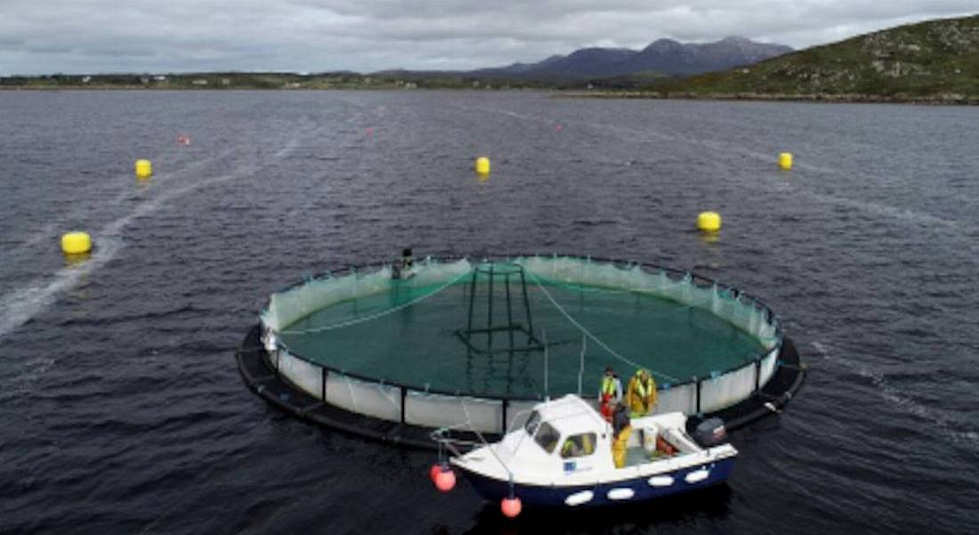 View of Lehanagh Pool site, Connemara Co Galway, showing a boat parked at a fish farm at the Marine Institute's research site.