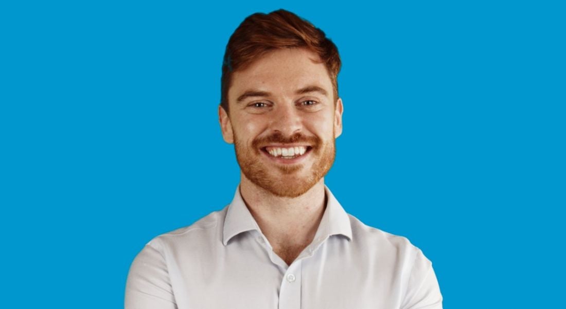 TJ Hegarty, founder of online tutoring business Breakthrough Maths pictured against a blue background.