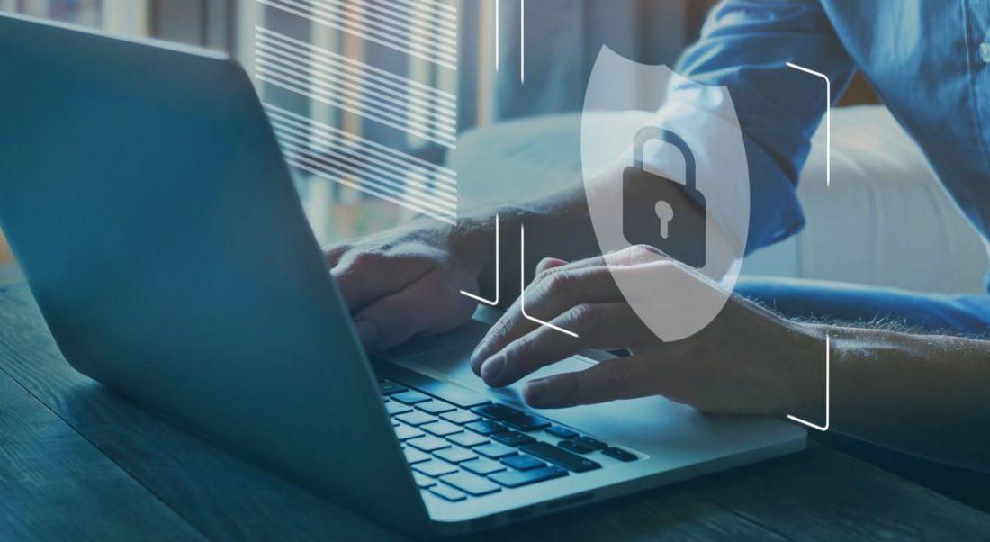 A stock image of a laptop with a lock and shield graphic representing cybersecurity.