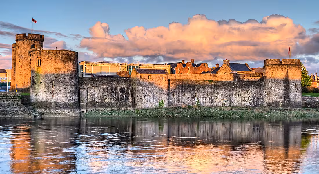 King John Castle in Limerick at sunset from across the water.