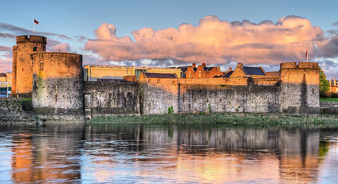 King John Castle in Limerick at sunset from across the water.