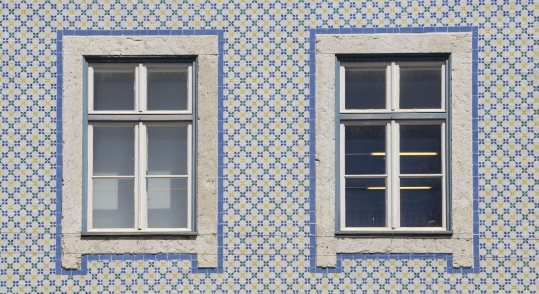 Two windows in a tiled wall.