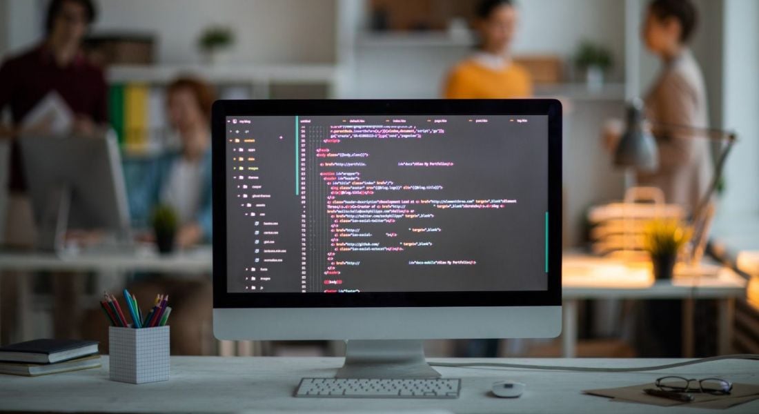 A computer screen in an office has lines of code on it, representing one of the top engineering skills.