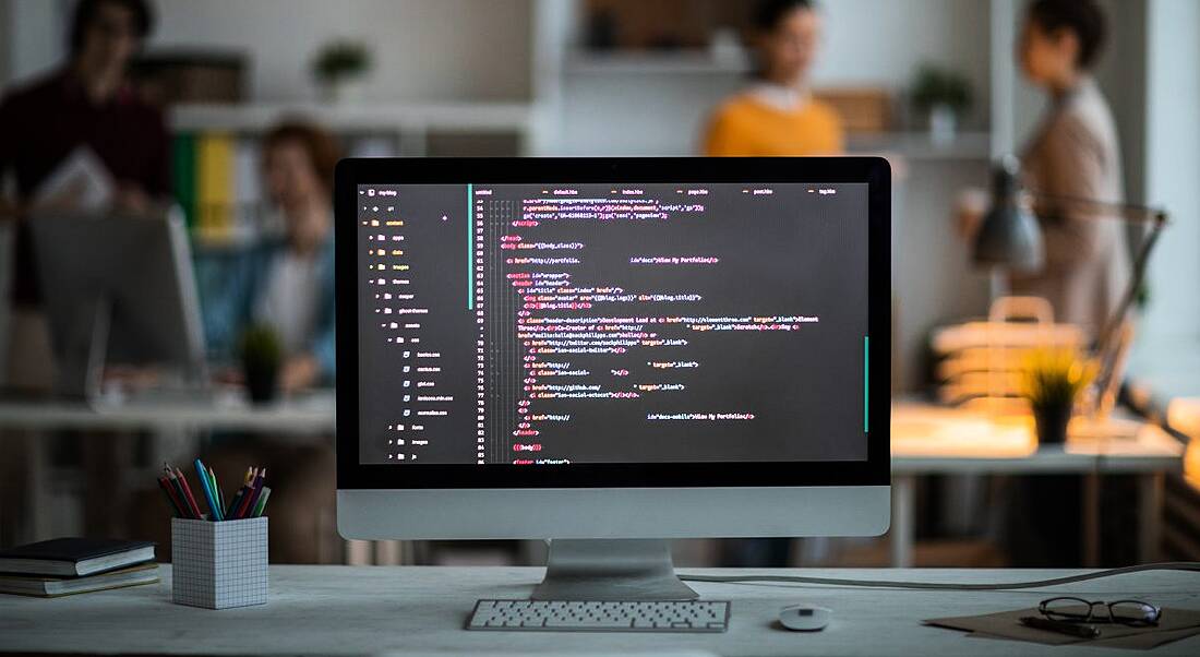 A computer screen in an office has lines of code on it, representing one of the top engineering skills.