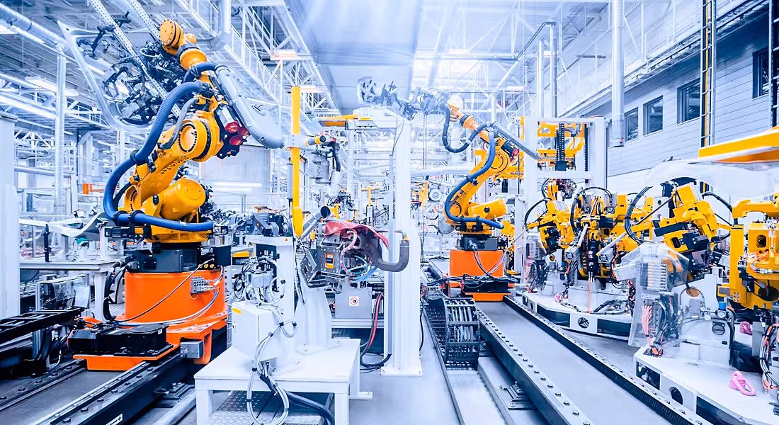 Robotic arms at work in an automation manufacturing lab.